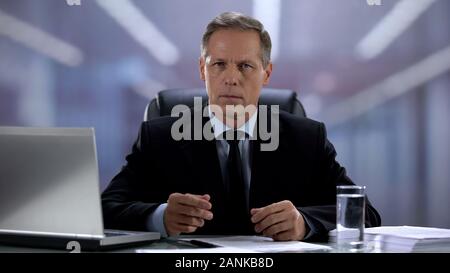 Serious boss suspiciously looking at camera, employer choosing worker, interview Stock Photo