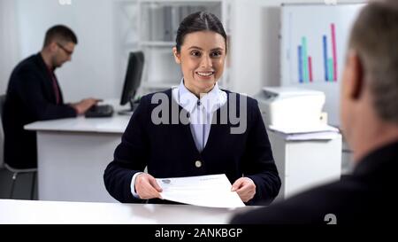 Smiling young job applicant giving curriculum vitae to hr manager, interview Stock Photo