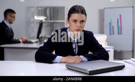 Nervous female call manager sitting in front of laptop, hard working day concept Stock Photo