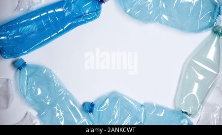 Empty plastic bottles lying on white background, utilization concept, ecology Stock Photo