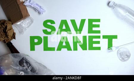 Garbage lying around save planet phrase against white background ecology concept Stock Photo