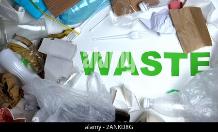 Garbage lying around waste phrase against white background, ecology concept Stock Photo