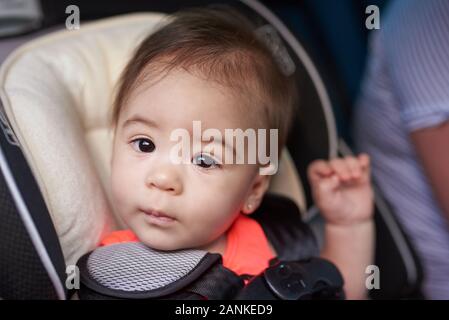 Car safety theme. Portrait of kid in car seat Stock Photo
