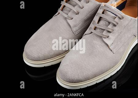 Gray man casual shoes isolated on black background