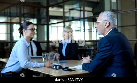 Male company director holding team meeting in office, discussing sales results Stock Photo