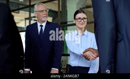 Happy business partners meeting in office, colleagues shaking hands, success Stock Photo