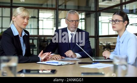 Sly women looking each other meeting boss, competition for career promotion Stock Photo