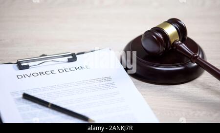 Divorce decree on table, gavel lying on sound block, court proceeding, rights Stock Photo