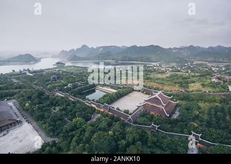 Ninh Binh, Vietnam - May 2019: aerial view from Bai Dinh stupa over Buddhist temple complex and mountains Stock Photo