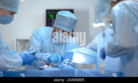 Surgeon team working in operation room, performing cardiothoracic surgery Stock Photo