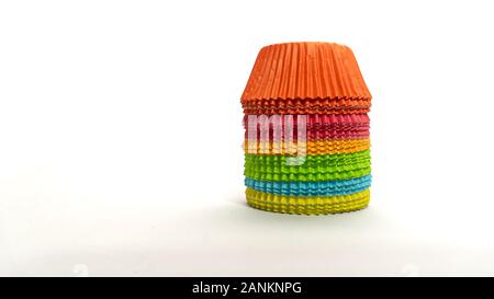 Rainbow of colorful cupcake wrappers stacked upside down on a white background Stock Photo