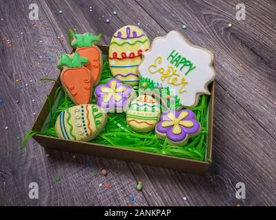 Closeup of Happy Easter Sugar Cookie Gift Box with Assorted carrot, flower, and egg cookies Stock Photo