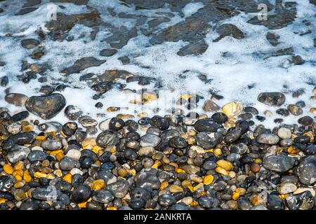 Swirling seas on a North Norfolk Pebble Beach, UK Stock Photo