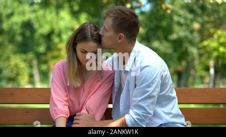 Boyfriend hugging girlfriend supporting hard time caring husband comforting wife Stock Photo