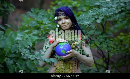 Earth mother holding planet in hands, environmental protection, nature care Stock Photo