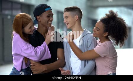 Happy couples of young people spending time together outdoors, friendship fun Stock Photo