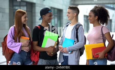 Group of multiethnic students laughing outdoors, friendship leisure, campus Stock Photo