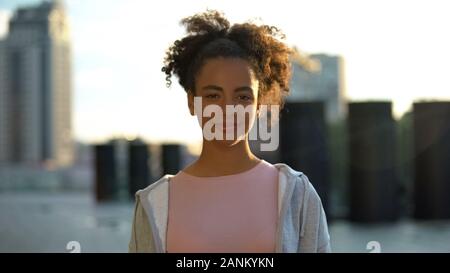Cheerful mixed-race female teenager sincerely smiling on camera youth and future Stock Photo
