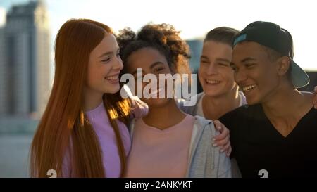 Multi-ethnic high best friends smiling camera and hugging, trustful relations Stock Photo