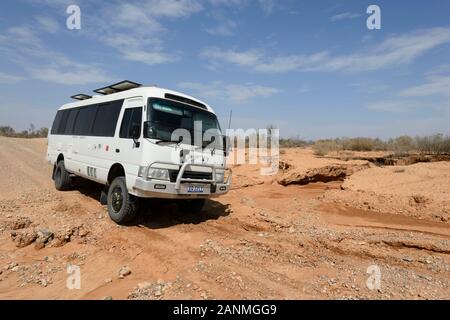 A four wheel drive Toyota Coaster negotiating a wash out in the Flinders Ranges National Park, South Australia, Australia Stock Photo