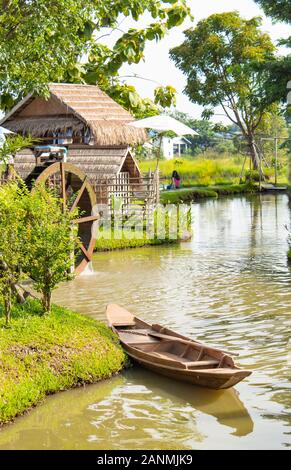 Wooden boat floating in nature water. Stock Photo