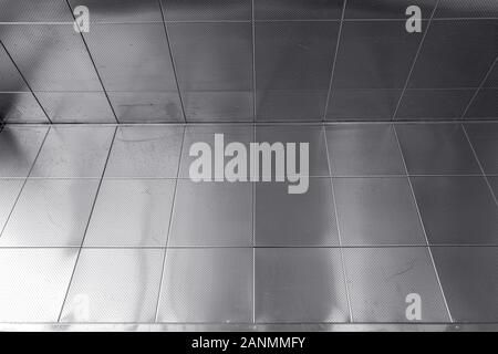 Shiny Metal Perforated Tiles in a Corner Stock Photo