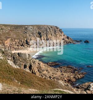 Sea cliffs, Cornish coastline and Porthleven Beach as seen from coastal path on a late Summer day in September with blue sky, Cornwall, England, UK Stock Photo