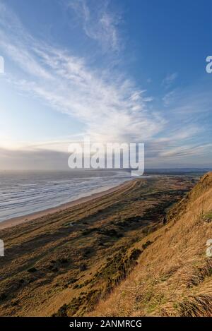 Looking south over St Cyrus Beach and Nature Reserve in Bright sunny storm conditions with heavy seas and rows of waves going on to the Beach. Stock Photo