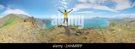 Man and mountain sea landscape panorama. Emotional and conceptual scene. Stock Photo