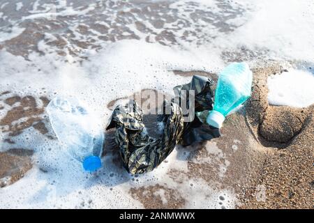 Used Plastic On Shore. Environmental Pollution Concept Stock Photo