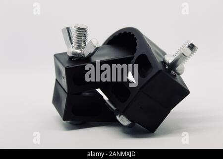 Two Black Plastic Clamps Interlocked with Screwblolts and Wing Bolts Stock Photo