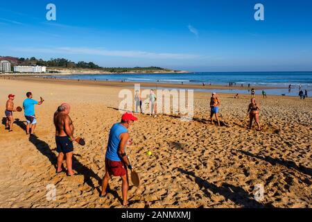 Playing beach tennis in Sardinero beach. Santander. Cantabria. north Spain, Europe Stock Photo