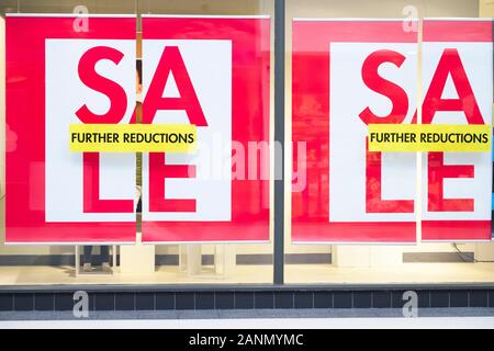 Closing down sale sign with further reductions and discount in shop store mall window Stock Photo