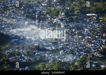 View from above, stunning aerial view of the Sembalun village illuminated at sunrise. Sembalun is situated on the slope of mount Rinjani. Stock Photo