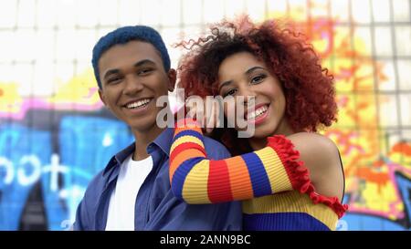 Positive stylish young couple smiling camera having fun, modern teenage fashion Stock Photo