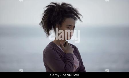 Biracial girl with muddy face looking sad, homeless teenager feeling lonely Stock Photo