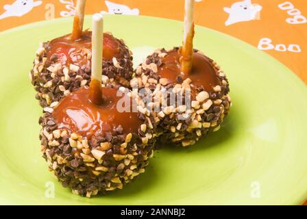 Toffee candy apples with a caramel glaze and dipped in chocolate chips and crushed peanuts. Stock Photo