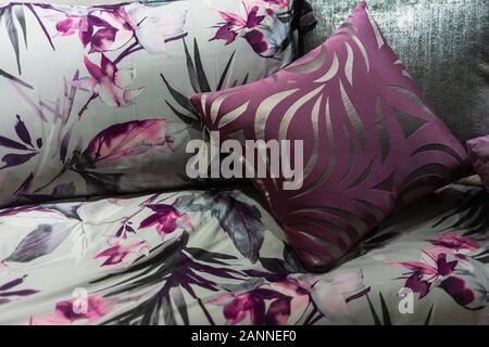 Beautiful soft pillow and blanket with white cozy bed in contemporary bedroom design ideas concept Stock Photo
