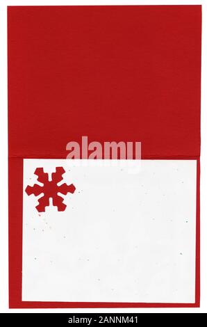 Blank Christmas card. High resolution scan shows all the detail.. Red and white heavy paper card stock is the background with a snowflake cut out. Stock Photo