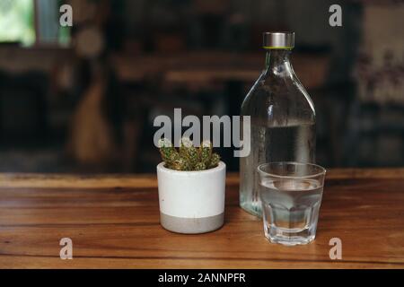 Drinking water. Glass of water with a bottle on table Stock Photo
