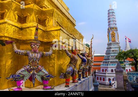 BANGKOK, THAILAND - DEC. 23, 2018: Guardian Yaksha statues surround Bangkok's Wat Phra Kaew (also known as the Temple of the Emerald Buddha).