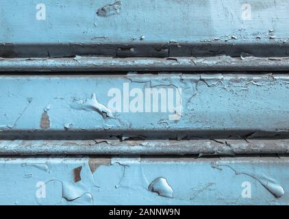 Background of old metal sheet with peel paint texture surface. Painted metal roller shutters door with peeling paint dirty hue. Grungy background text Stock Photo