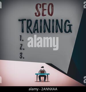 Handwriting text Seo Training. Conceptual photo learn specific knowledge improve perforanalysisce in current roles View young man sitting chair desk w Stock Photo