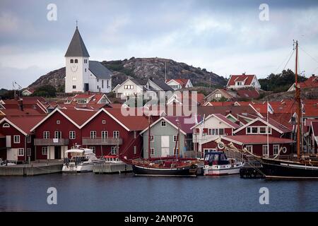 The fishing village of Fjallbacka in Bohuslan county, red buildings and marina, Sweden Stock Photo