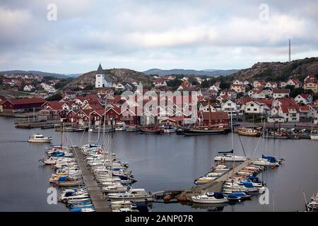 The fishing village of Fjallbacka in Bohuslan county, red buildings and marina, Sweden Stock Photo