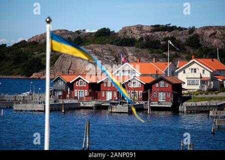 The fishing village of Fjallbacka in Bohuslan county, red buildings and marina, Sweden Stock Photo