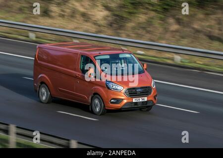 Ford Transit Custom 300 Limited Orange LCV Diesel driving on the M6 motorway near Preston in Lancashire, UK Stock Photo