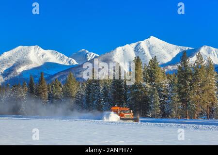 snowplow clearing the runway of the airport at seeley lake, montana Stock Photo