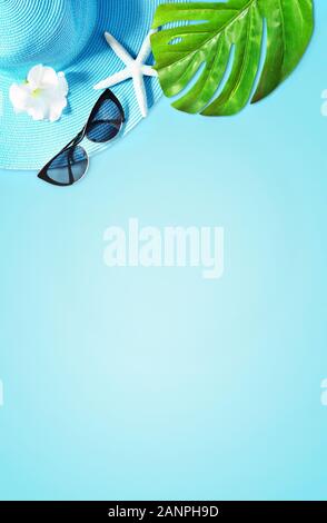 Tropical Summer Beach Background. Palm Trees Branches, hat with starfish on blue summer background. Travel. Copy space. Summer concept. Stock Photo