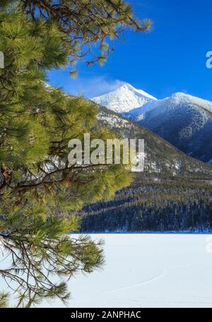 frozen holland lake below carmine peak in the swan range near condon, montana Stock Photo